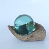 Glass bowl on wooden hand